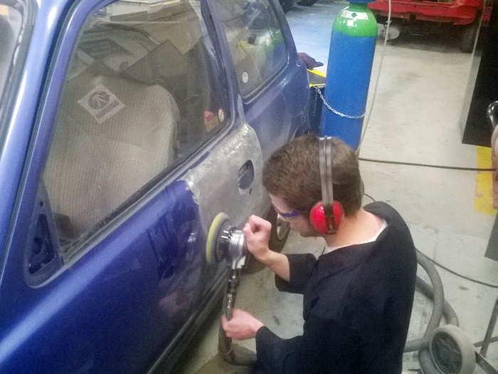 The driver’s door was badly damaged, all the paint needed to be removed with the dual action sander so he can start the next process