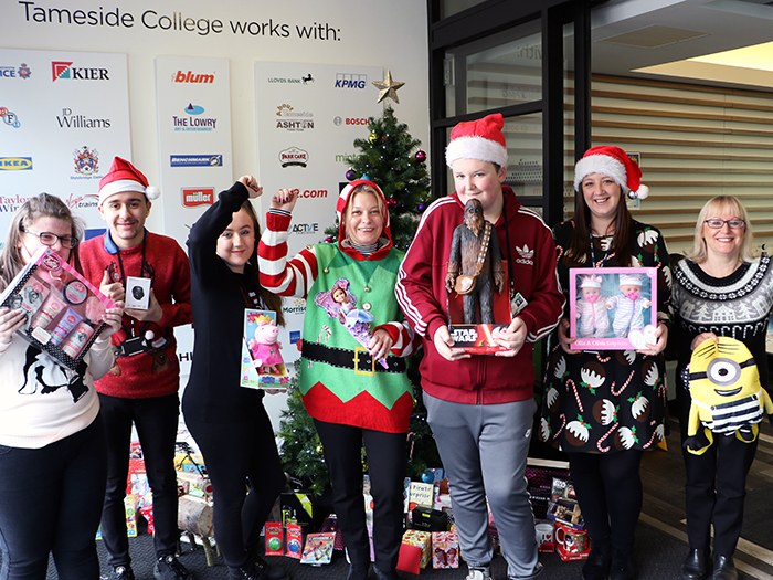 Staff and students with some of the donated gifts