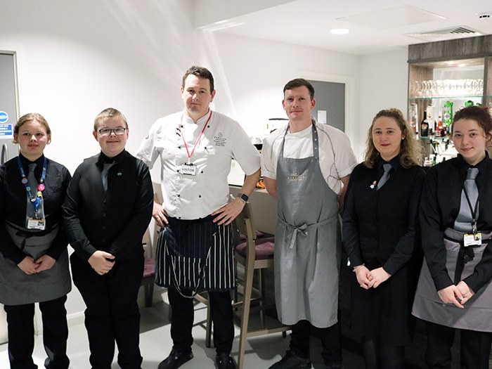 Students pose for a photo with Andrew