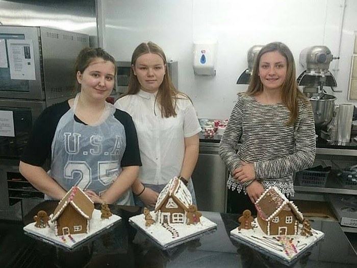 Competition winner present their gingerbread houses at the end of their tutorial