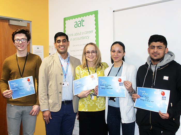 Kasim presenting students with certificates