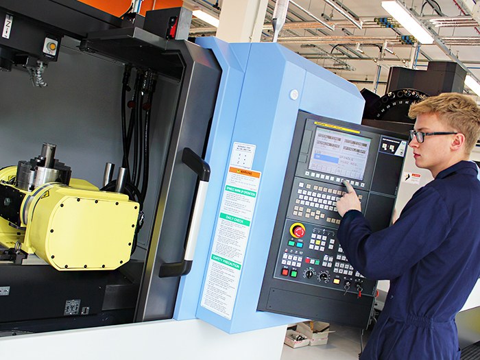 A student tries uses one of the new CNC machines