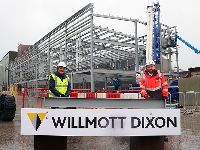 Jackie signs the steel with Josh at Willmott Dixon