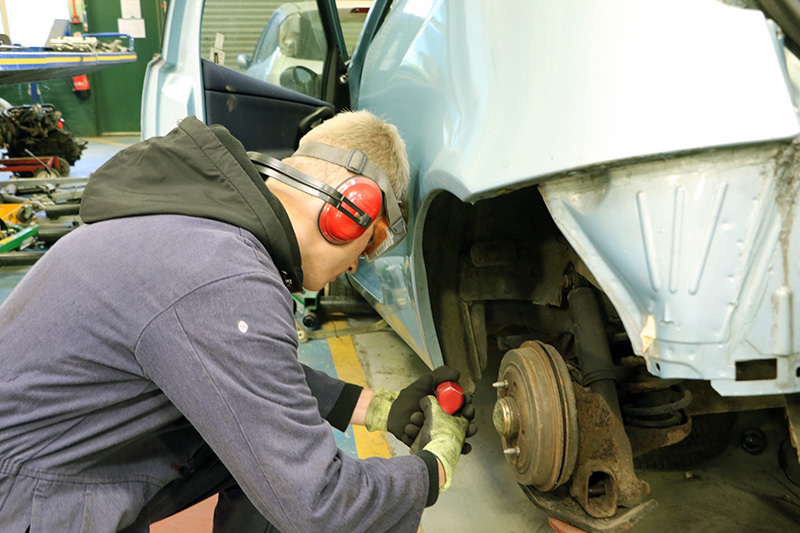 Terry is drilling out spot welds on the rear wheel arch of a Fiat Punto.
