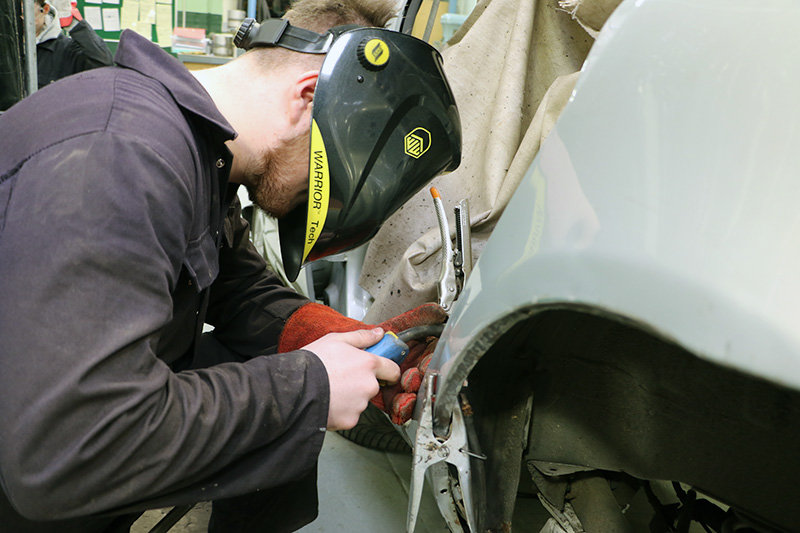 Christian is welding the rear quarter panel back into place on a Renault Clio.