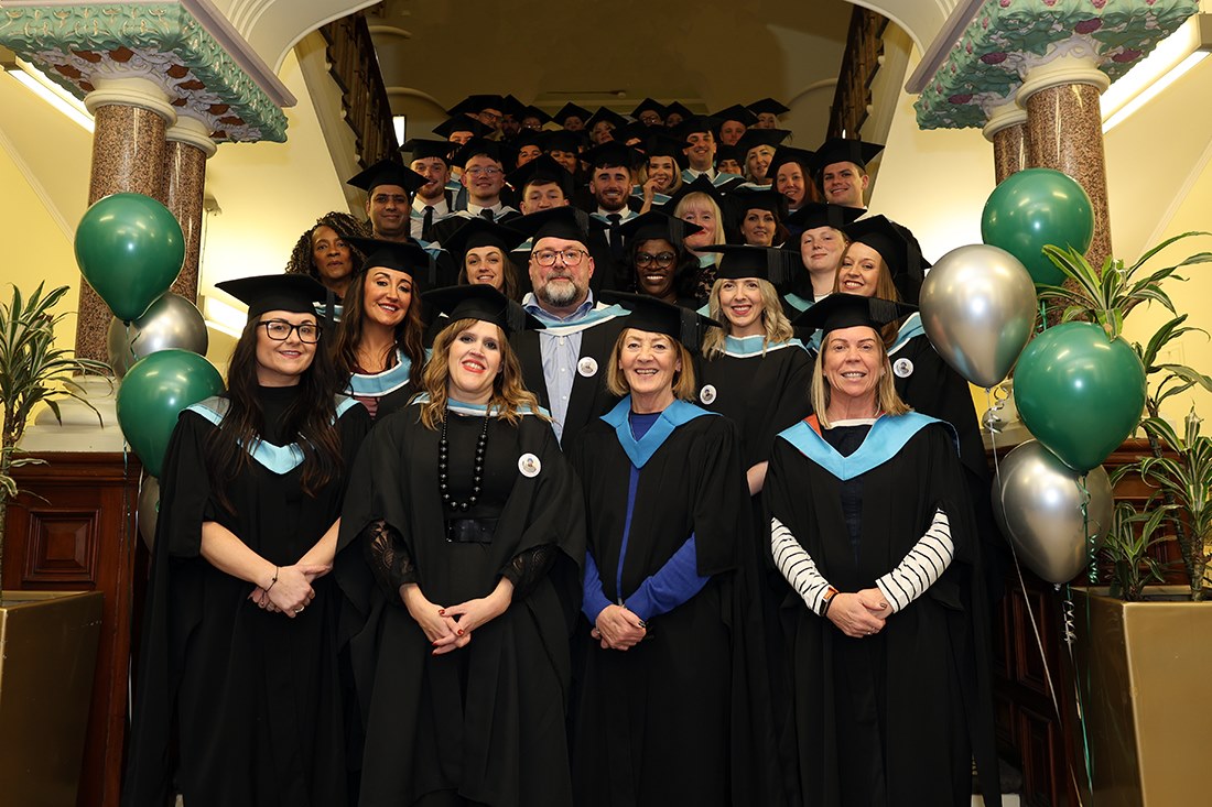 Students and staff gather after graduating