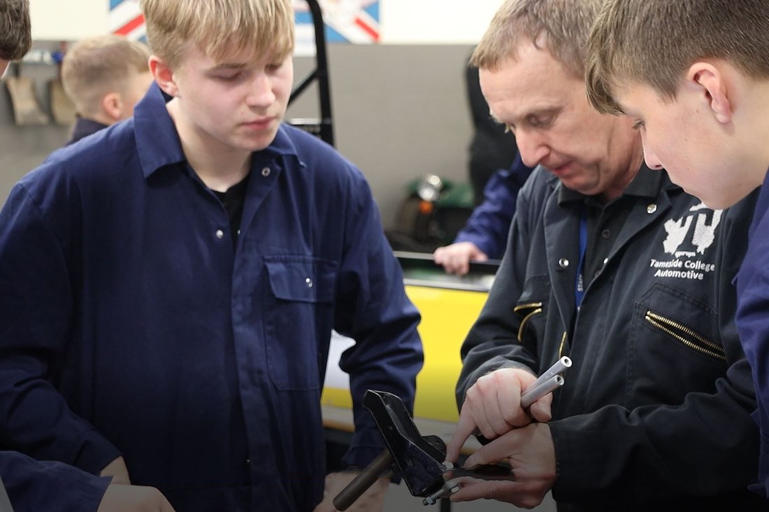 Students constructing the car with staff