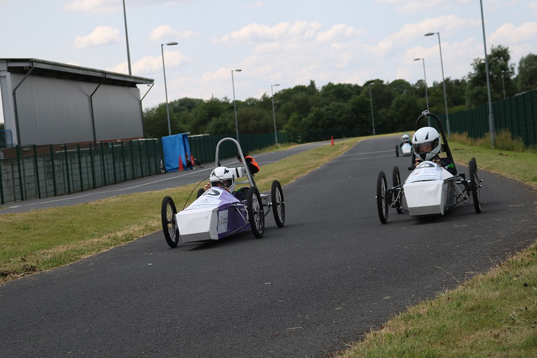 Students driving the finished cars on track