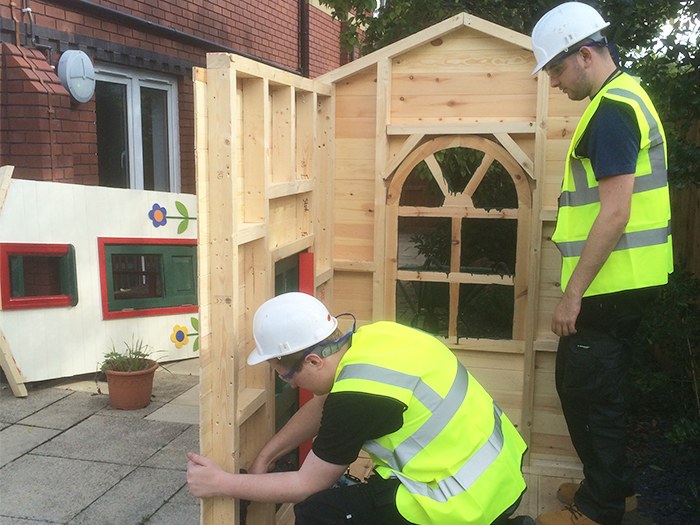 Students assembling the Wendy house at Grace