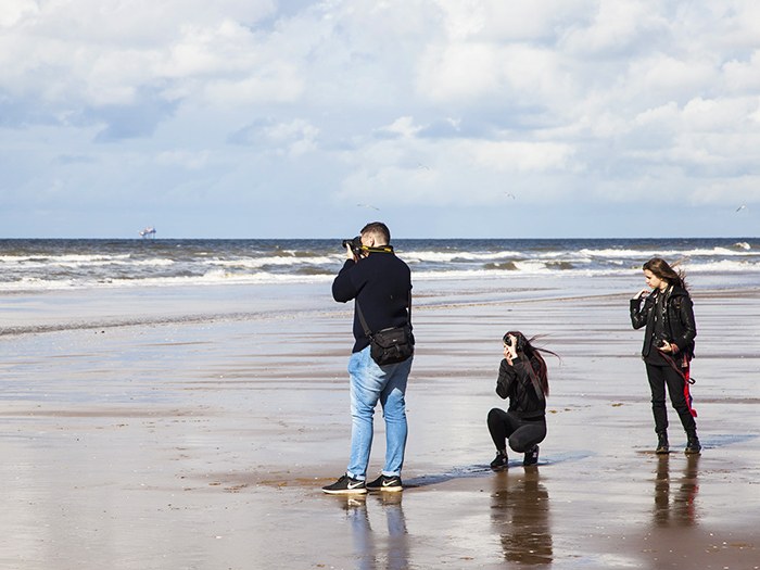 Photography students on the beach