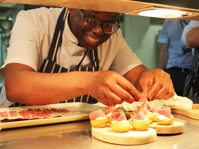 Chef Ray Jones arranges food plates for the guests