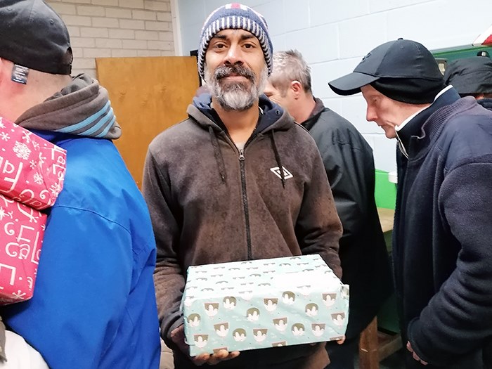 A homeless shelter user with their shoebox