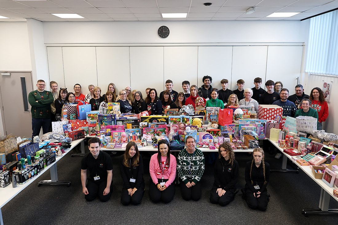 Students and staff with all the donated gifts