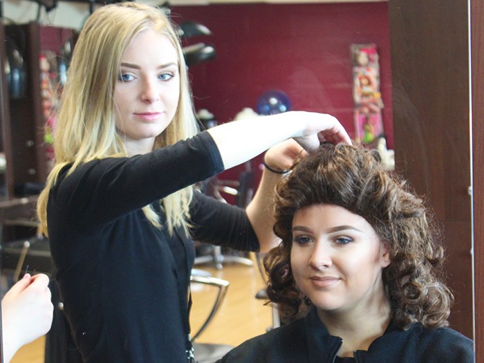 Students prepare the wigs